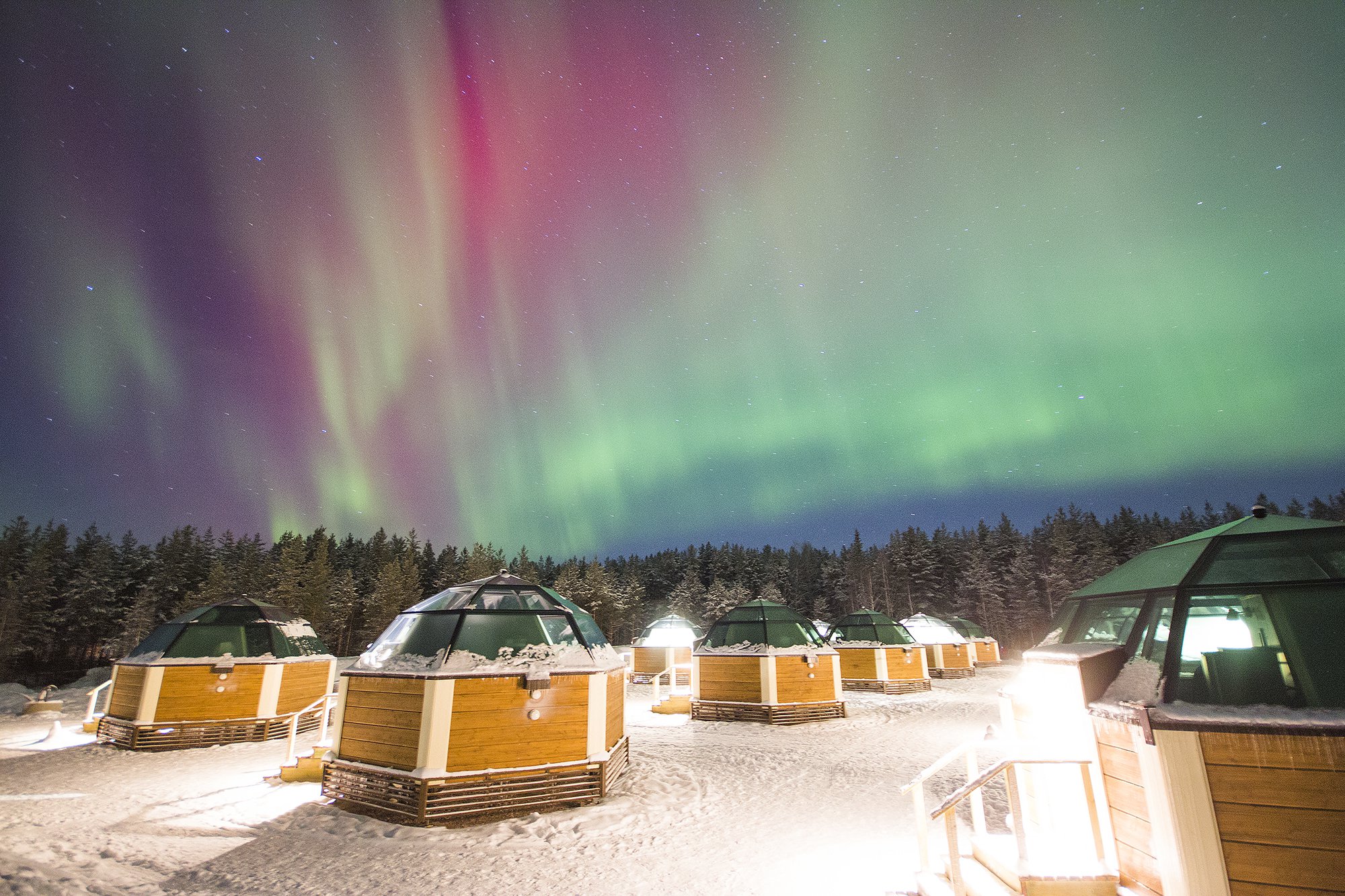 Northern Lights over the glass igloos at Snowhotel in Finnish Lapland