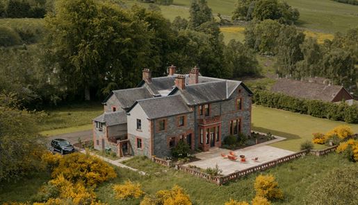 Ariel view of Dun Aluinn House and the woodlands beyond in Perthshire in Scotland