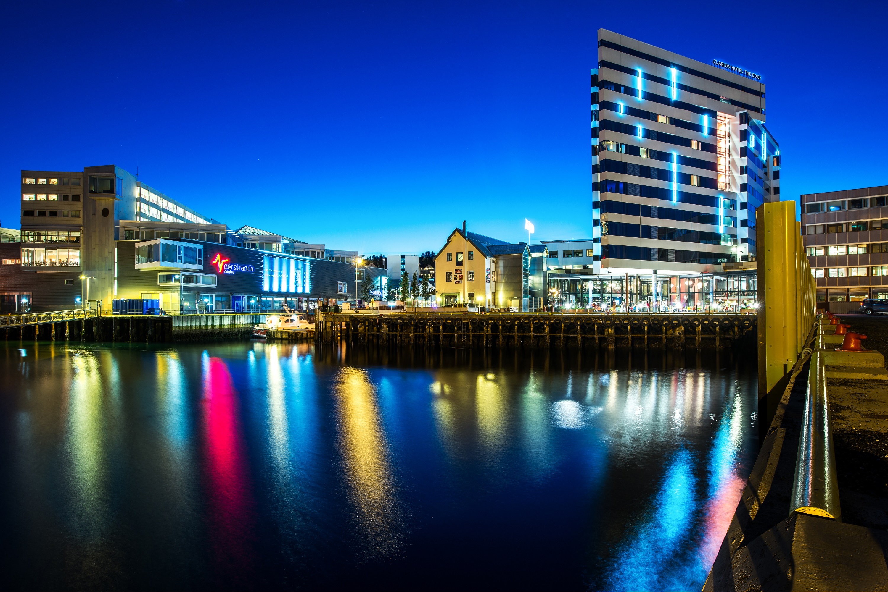 The facade of the striking Clarion Hotel the Edge next to the glistening water in Tromso in Norway.